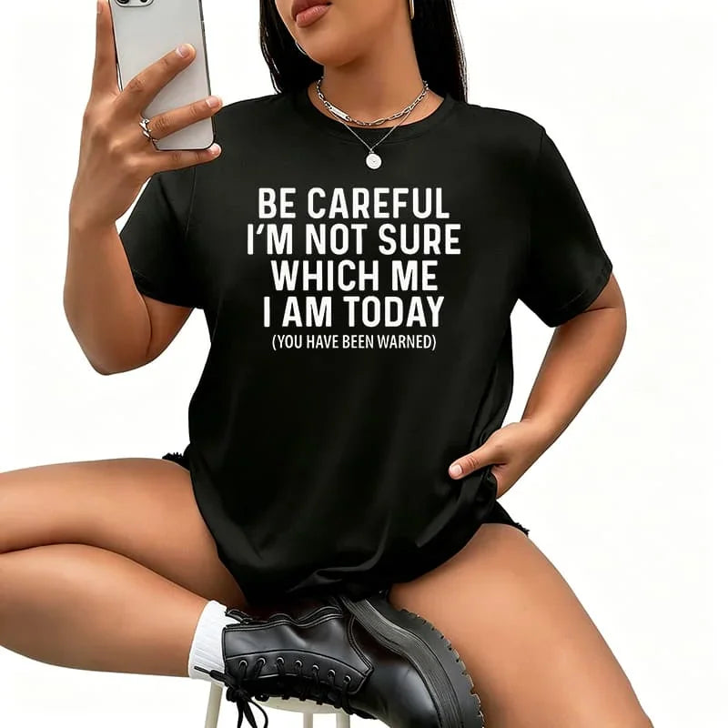 Woman wearing a black short sleeve cotton t-shirt with a white funny text graphic
