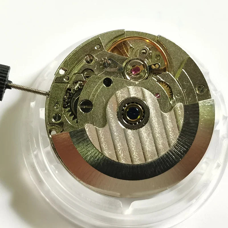 Back view of automatic mechanical watch movement with gold rotor.