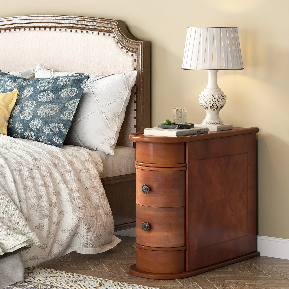Narrow wooden bedside table with two drawers in a bedroom setting, featuring a white lampshade on top