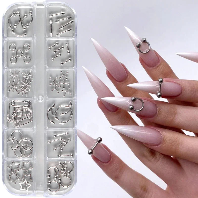 Silver metallic nail piercing charms and studs displayed in a storage organizer with a manicured hand model