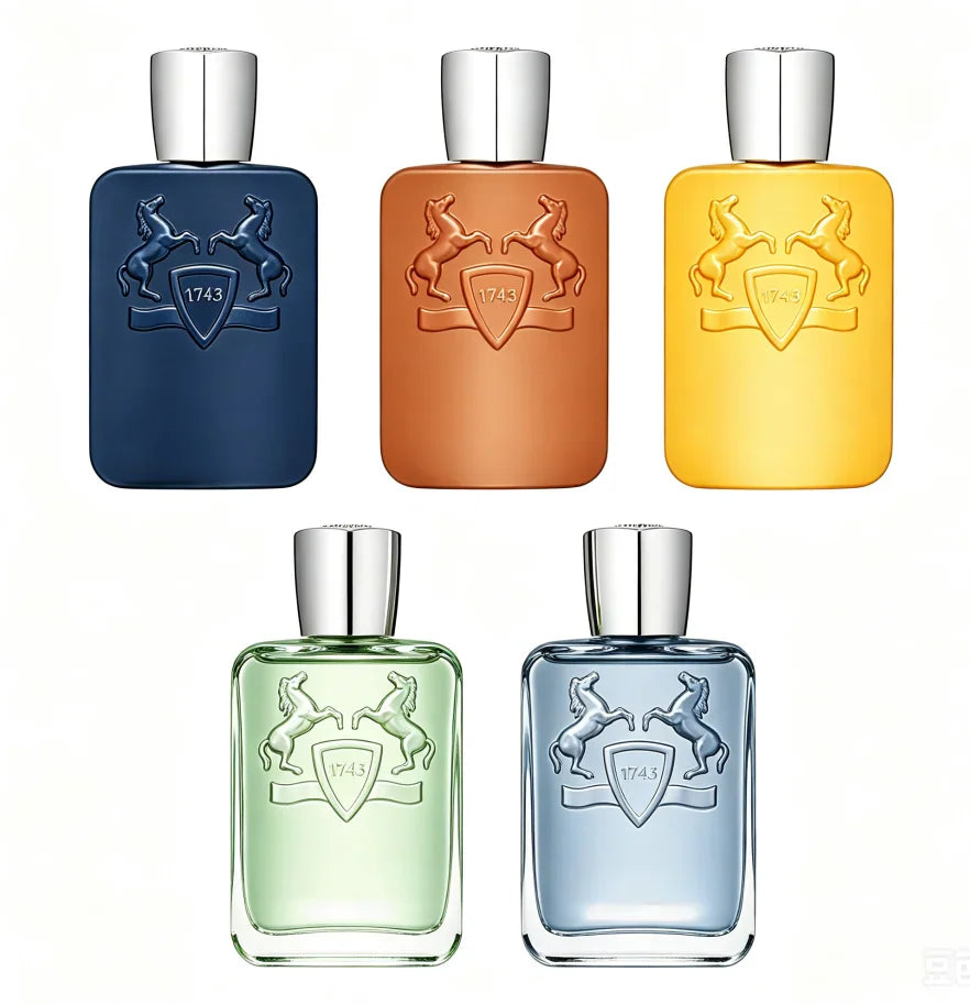 A collection of five Charming 1743 perfume spray bottles in various colors displayed in an elegant gift box.