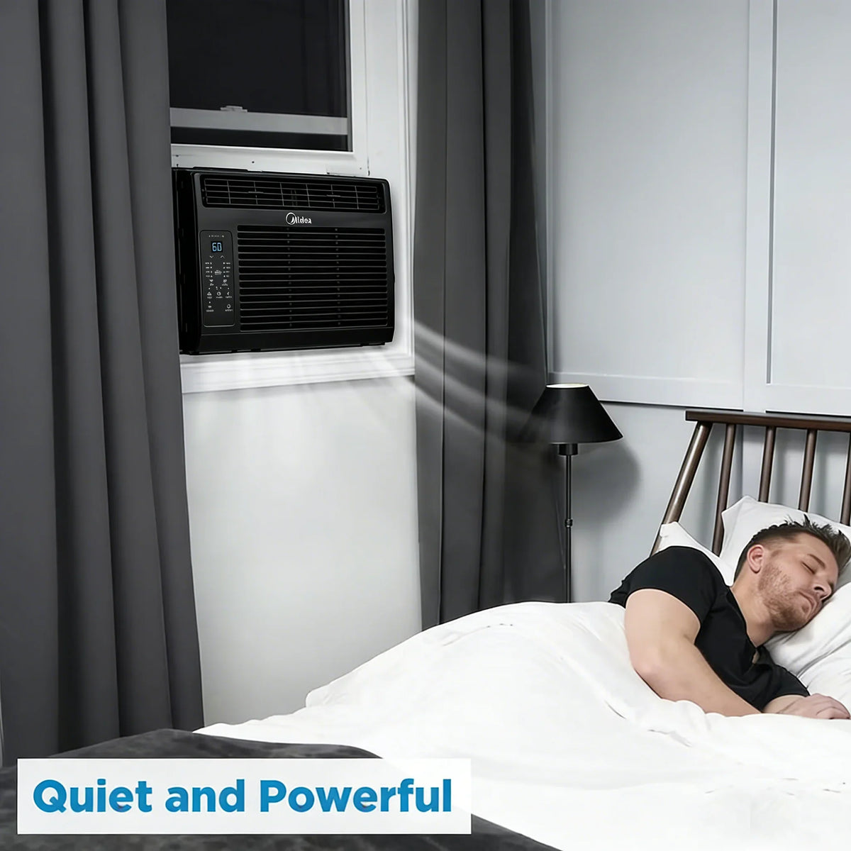 Black window air conditioner in a bedroom with a person sleeping
