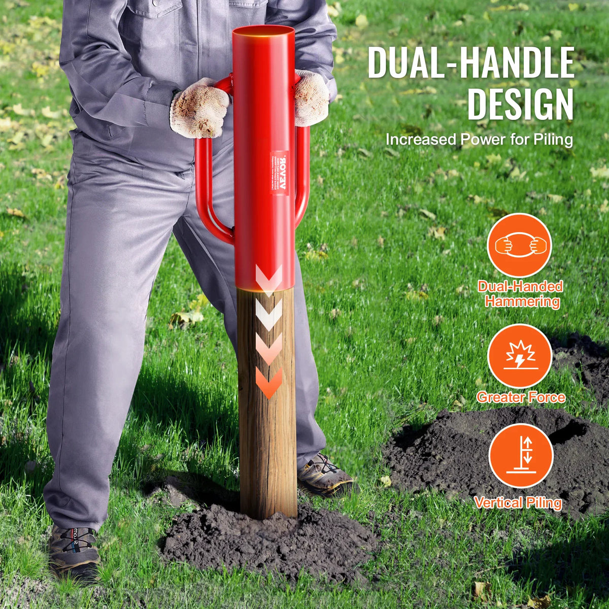 A worker using a red manual fence post driver to pound a post into the ground