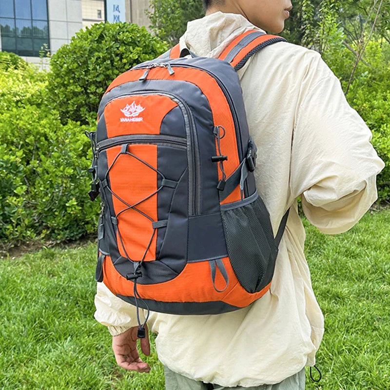 Person wearing an orange and grey hiking backpack