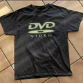 A black t-shirt with a pixelated graphic print that reads DVD VIDEO.