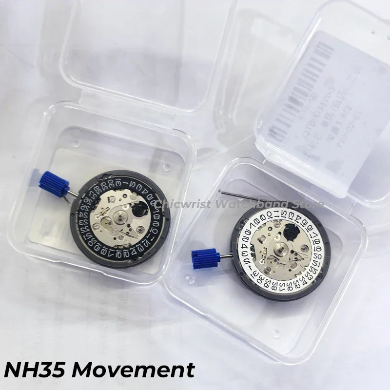 Two mechanical watch movements inside clear plastic cases with date wheels visible
