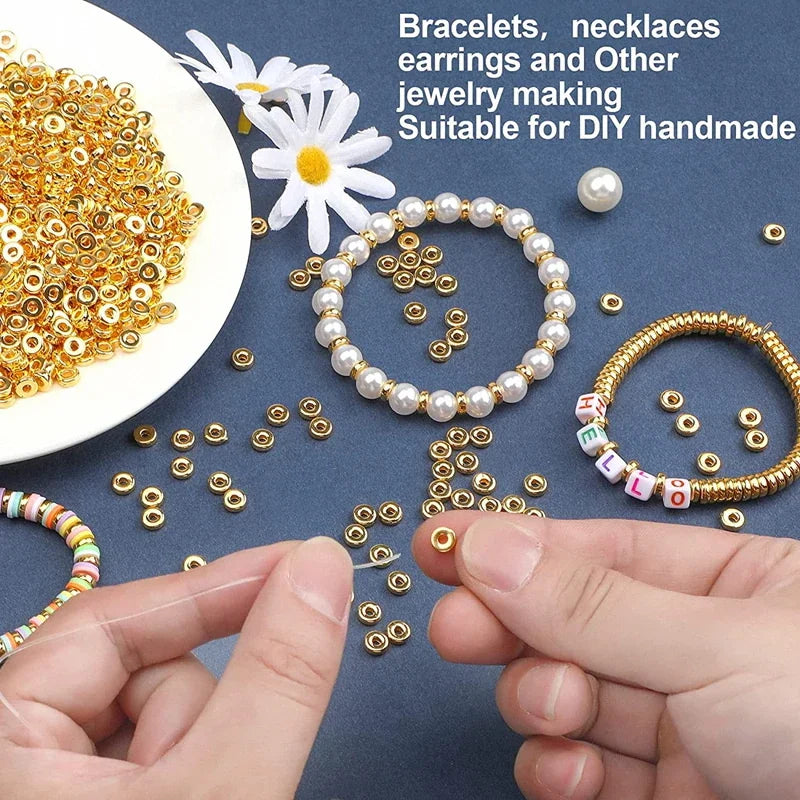 Flat gold round spacer beads with hands threading them onto a string to make bracelets