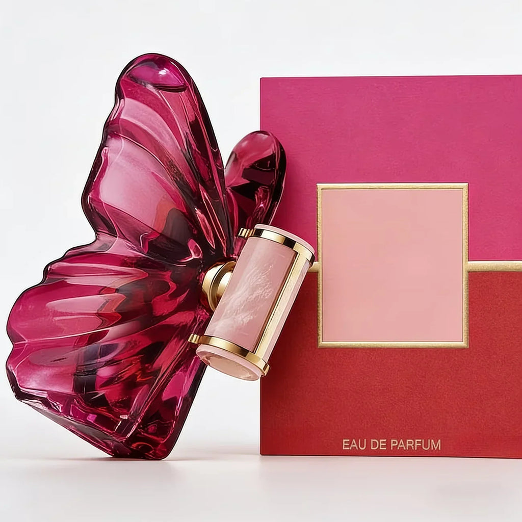 A pink butterfly-shaped glass perfume bottle next to its pink and red gift box.