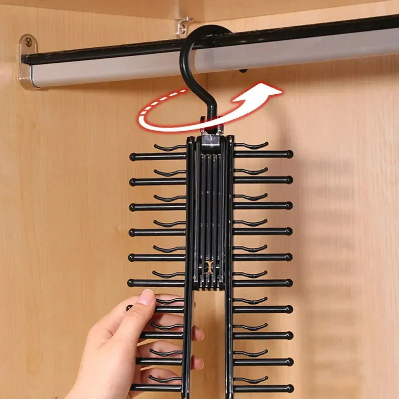 A hand rotating a black tie rack hanger with a graphical arrow indicating the movement.