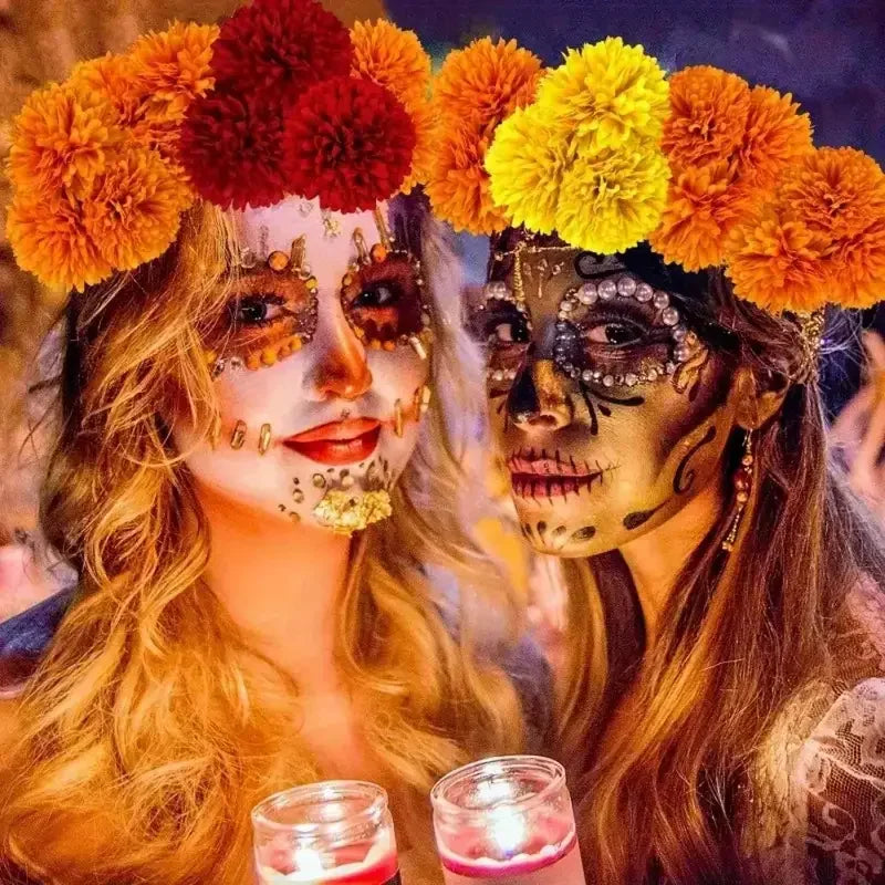 Two people wearing skull face paint and marigold flower crowns