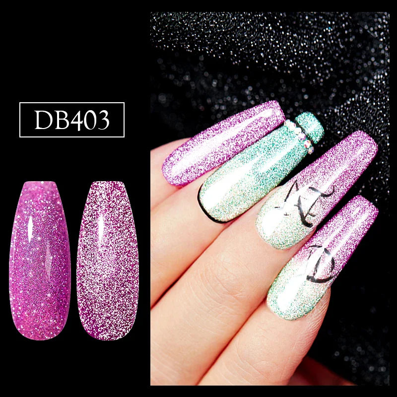 A close-up of a manicure using glittery purple and green gel polish with decorative line art.