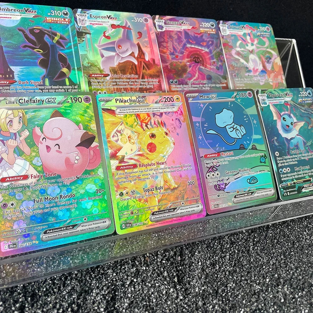Collection of eight holographic trading cards arranged in two rows in a clear plastic stand