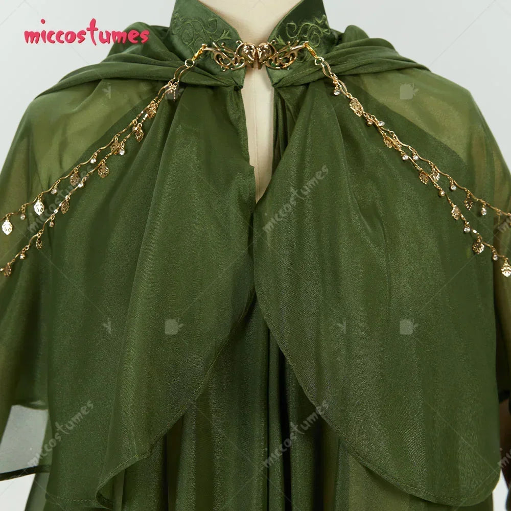 Close up of gold chain and leaf charms on a green hooded cloak