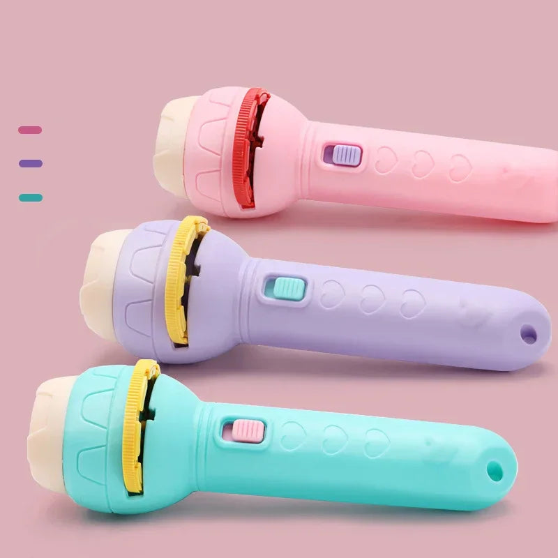Set of three colorful plastic flashlight projectors in pink, purple, and blue