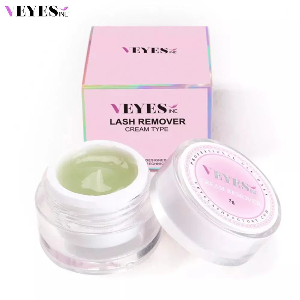 A small jar of green eyelash extension cream remover and its pink outer box packaging.