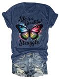 Blue t-shirt with a colorful butterfly graphic and the text Life is a Beautiful Struggle