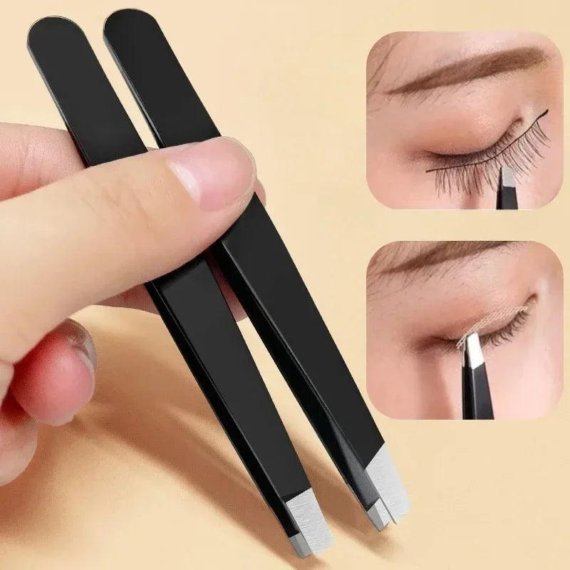 A pair of black stainless steel tweezers being used to apply or adjust false eyelashes on an eye
