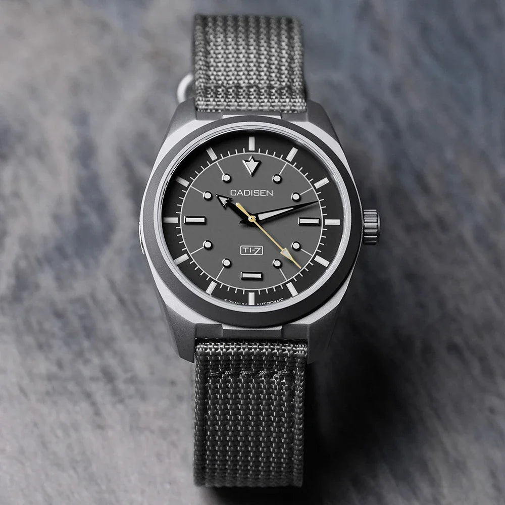 Grey titanium automatic watch with a grey canvas nato strap and black dial