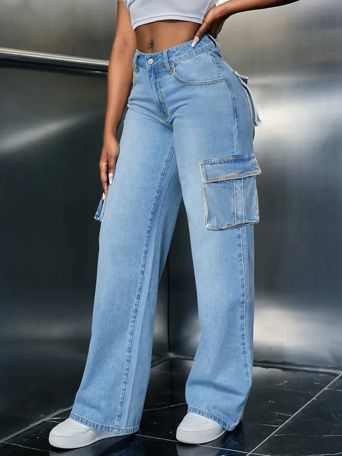 Side profile view of light blue straight leg cargo jeans featuring deep utility pockets.