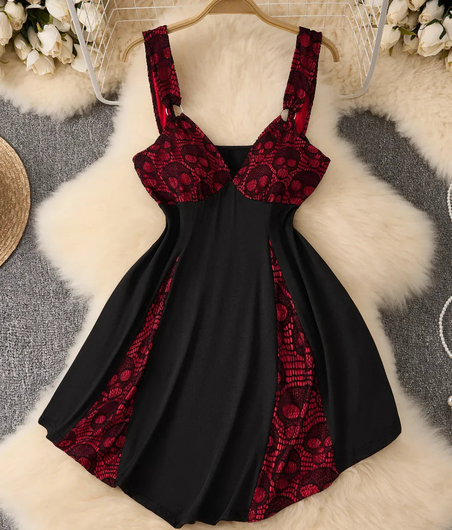 Gothic punk style black and red sleeveless dress with skull lace details and a strappy neckline.