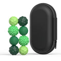 A set of green magnetic sensory fidget balls with different textures and a black storage case.