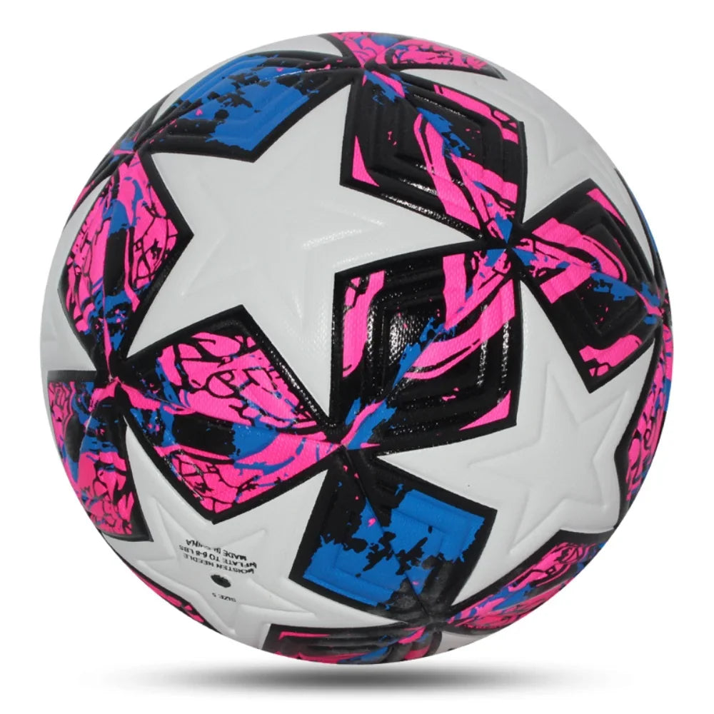A professional white soccer ball with pink and blue star patterns on a plain background