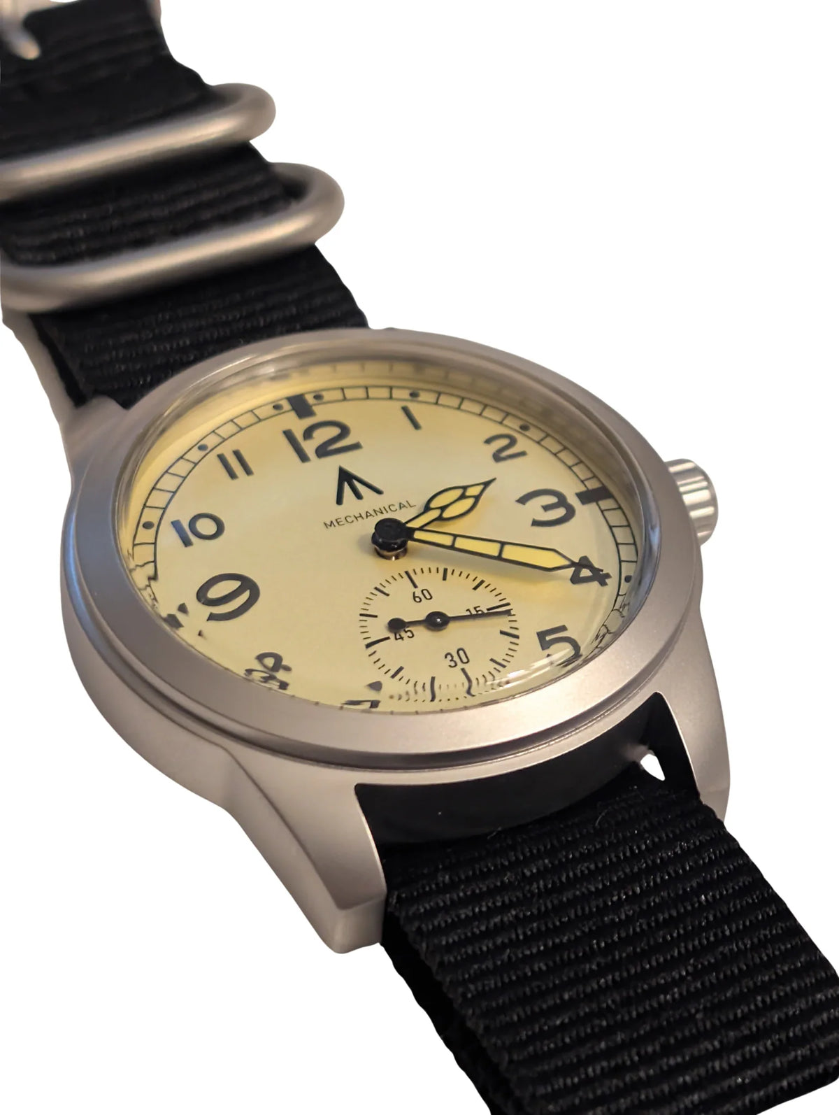 Angle view of cream dial field watch with sub-seconds dial on a black fabric watch strap