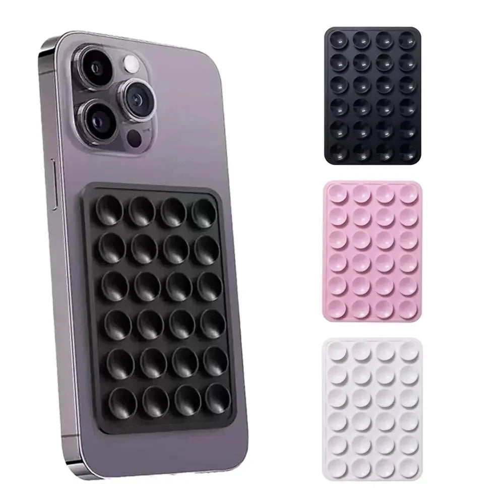 Silicone suction cup phone mount attachments in black, pink, and white attached to a smartphone
