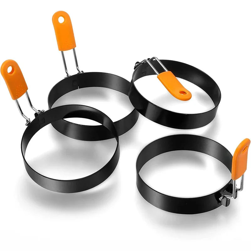 Set of three black stainless steel egg rings with orange silicone handles