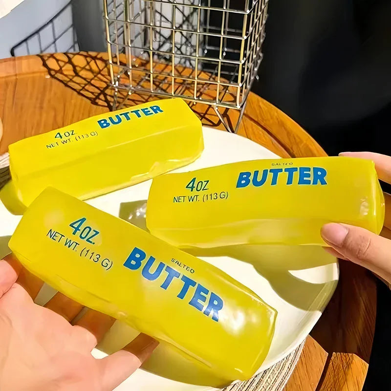 Hand holding multiple yellow butter stick shaped stress relief fidget toys