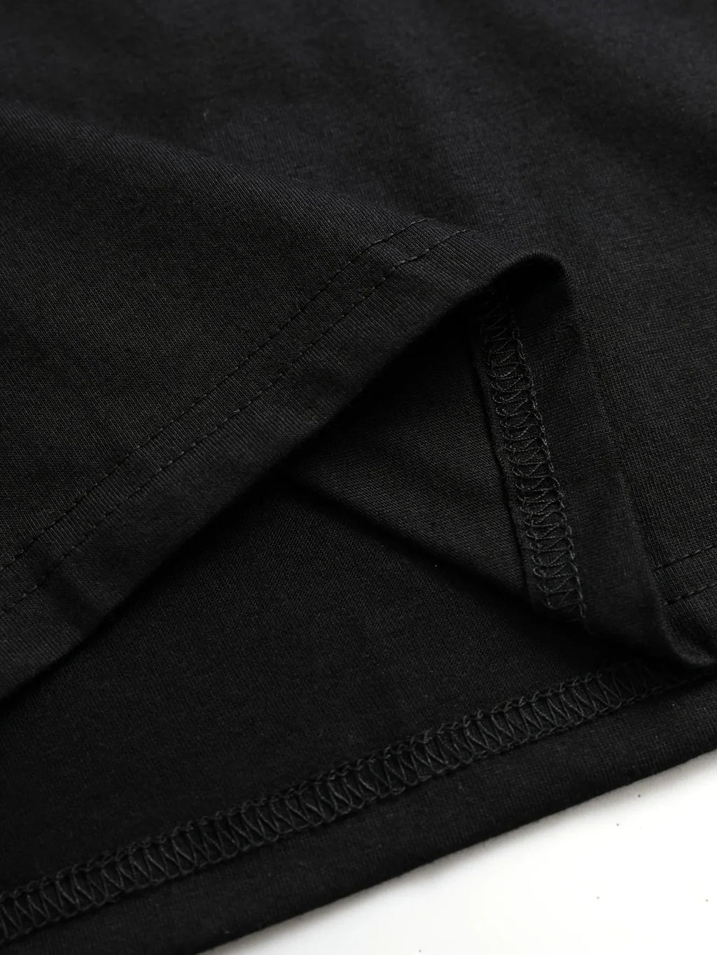 Close up of a black t-shirt hem stitching