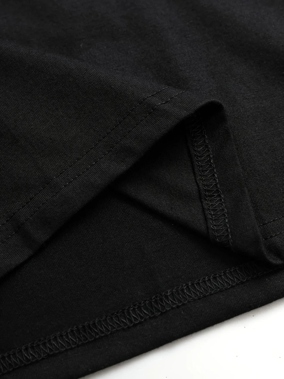 Close up of a black t-shirt hem stitching
