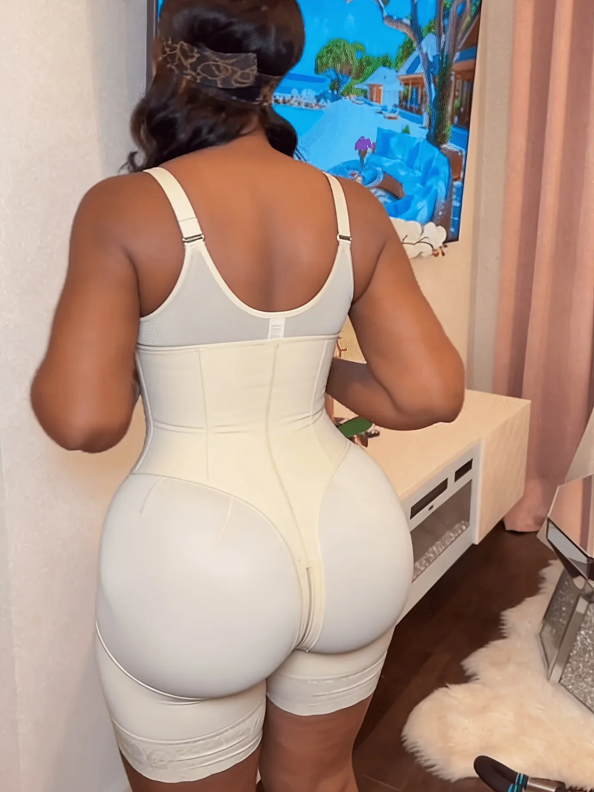 Back view of beige full body shaper bodysuit with lace leg hem