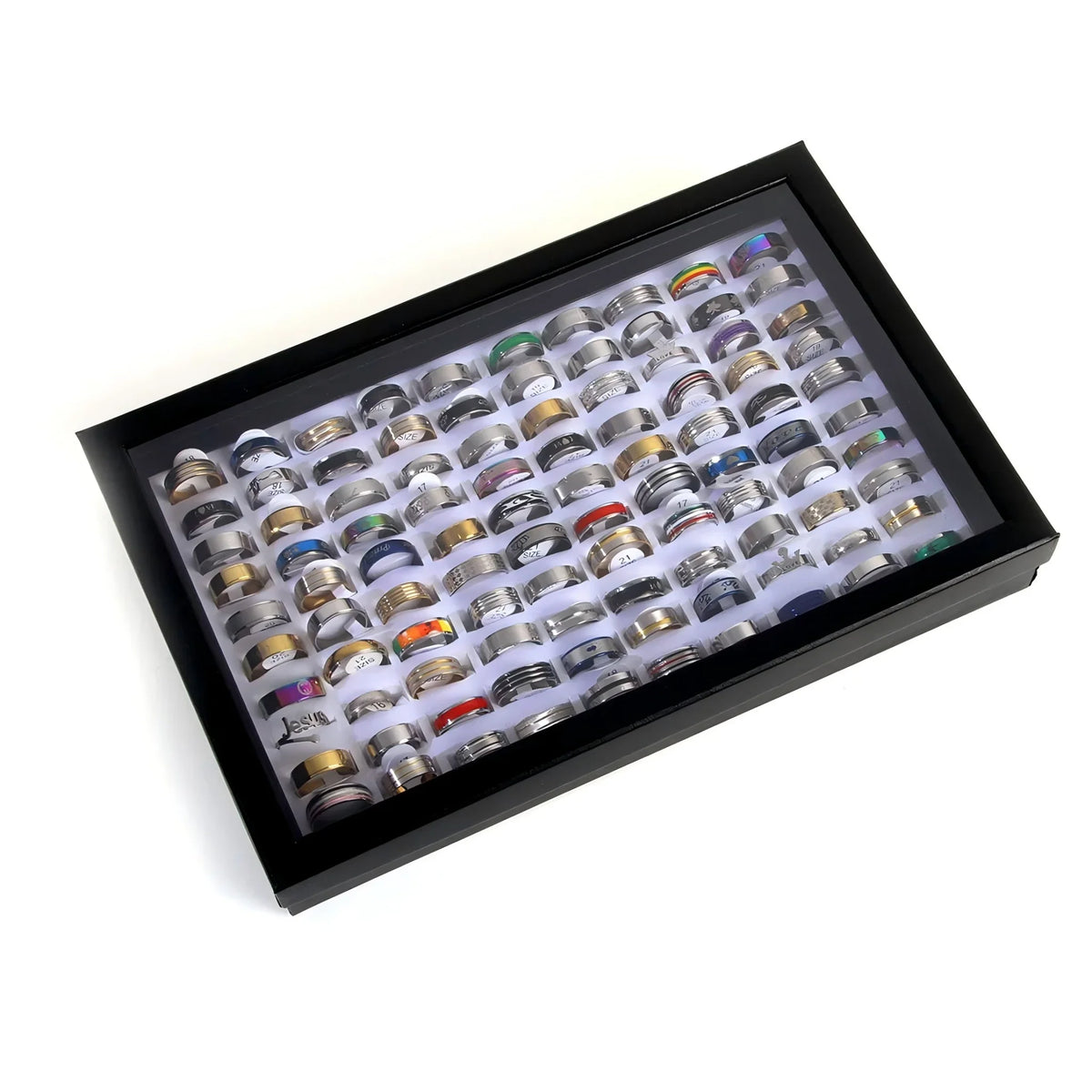 A wide assortment of mixed metal fashion rings displayed neatly inside a black velvet-lined storage box.