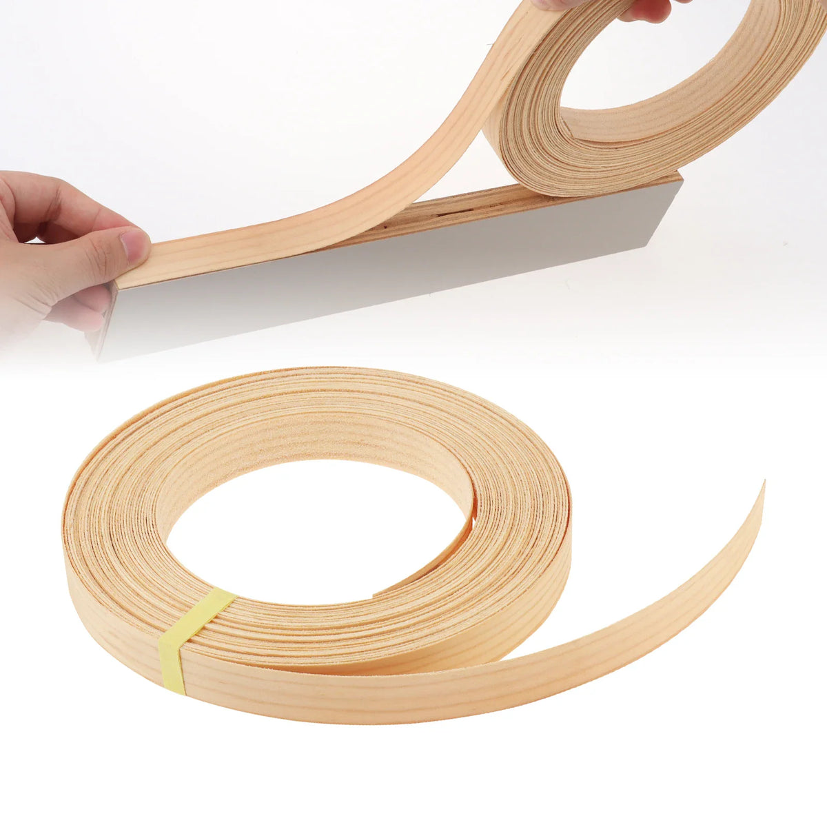 A roll of light-coloured wood veneer edge banding being applied to a cabinet edge