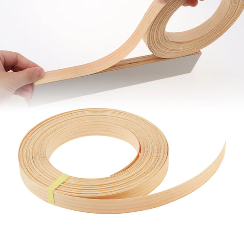 A roll of light-coloured wood veneer edge banding being applied to a cabinet edge