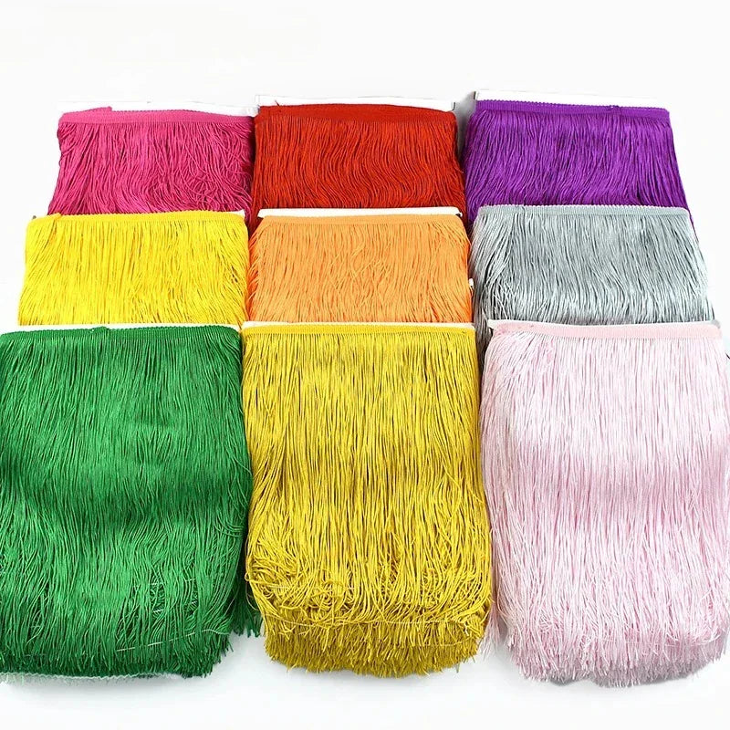 Nine colorful rolls of long tassel fringe trim arranged in a grid