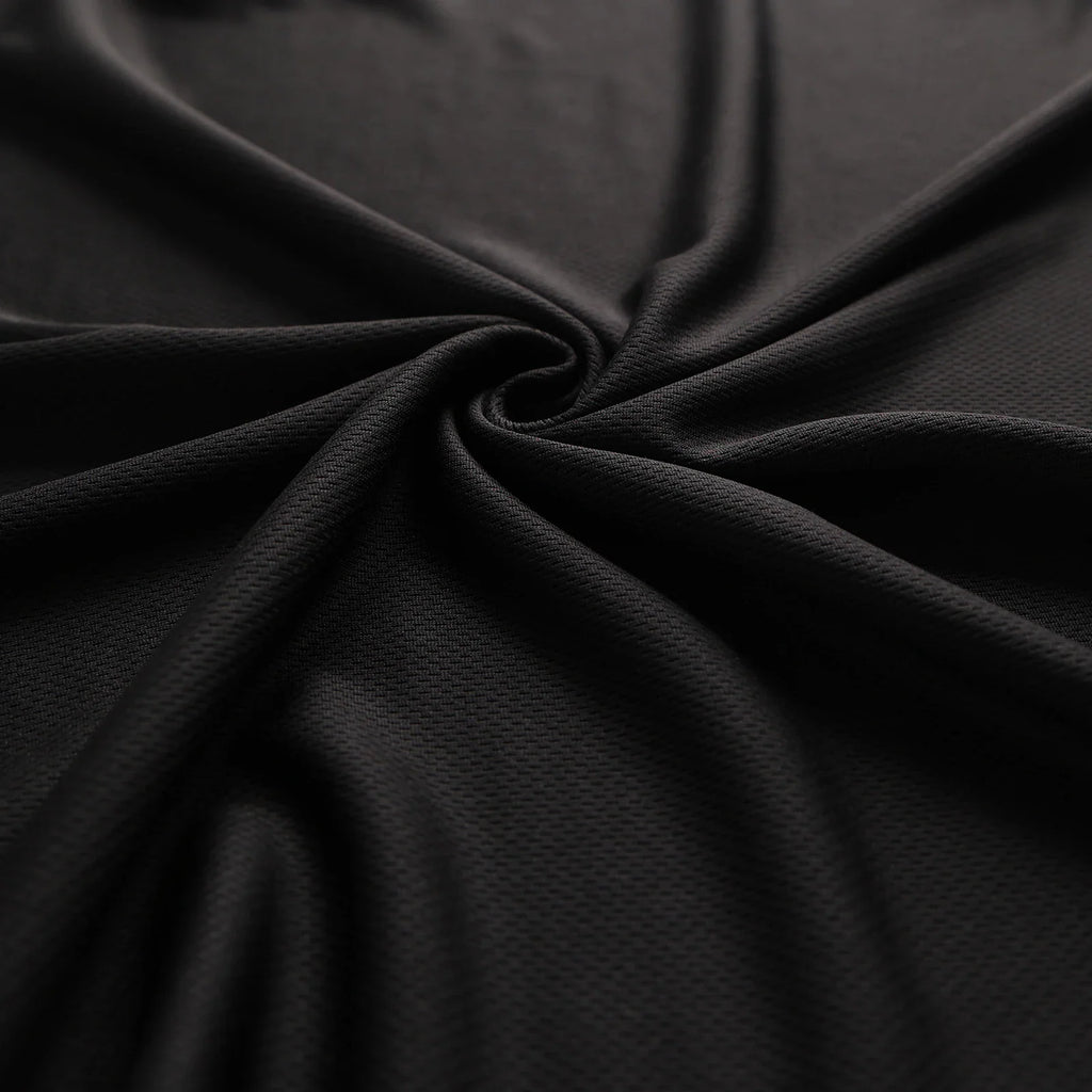 A close-up of the black moisture-wicking, quick-drying mesh fabric texture.