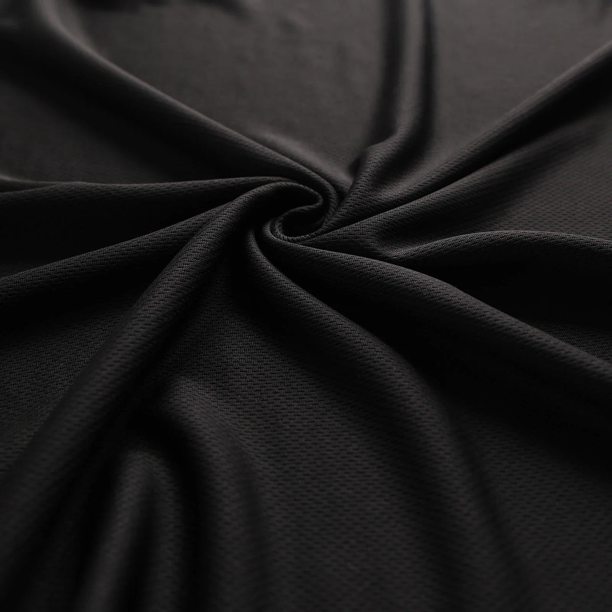 A close-up of the black moisture-wicking, quick-drying mesh fabric texture.
