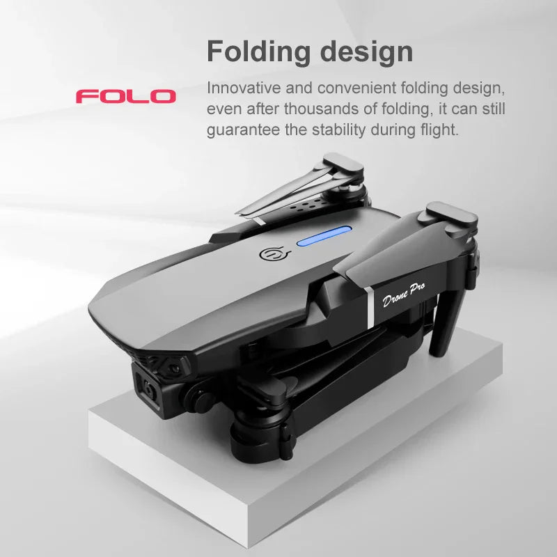 A folded black drone resting on a white stand with descriptive text about its folding design.