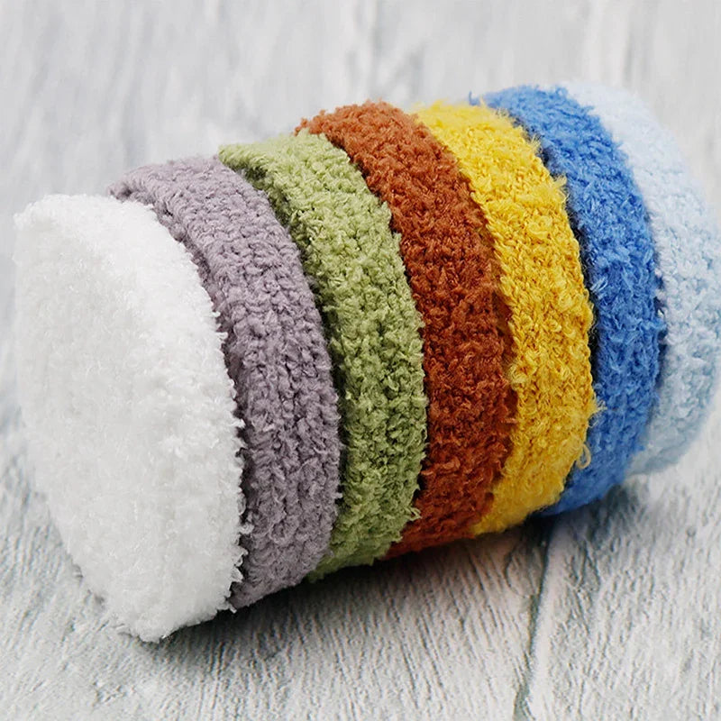A rolled bundle of multi-coloured fluffy plush shoelaces showcasing various colours.