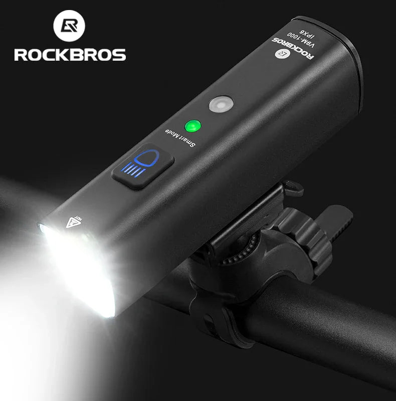 A black rechargeable LED front bike light mounted on a handlebar