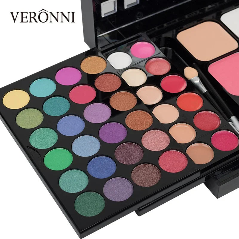 An open makeup palette with a variety of colorful eyeshadows and lip glosses