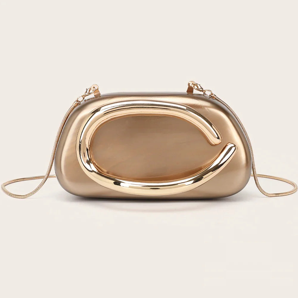 A bronze or dark gold marble-effect evening clutch with a gold-tone metallic oval ornament and a chain shoulder strap.