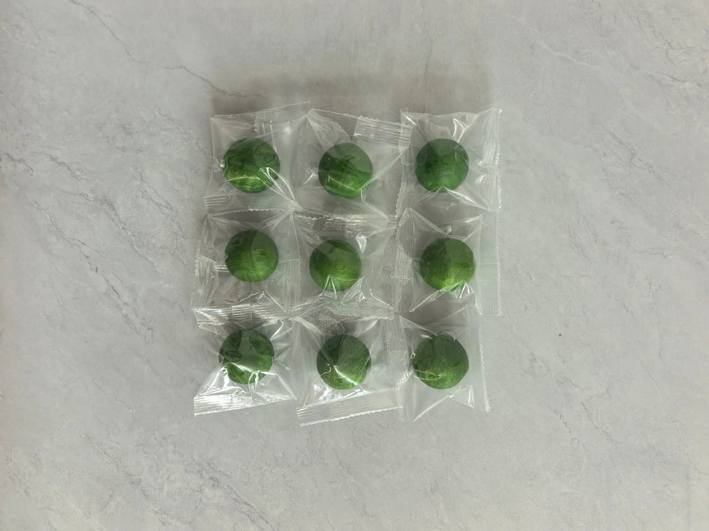 Nine green rodent repellent balls in individual clear plastic wrappers