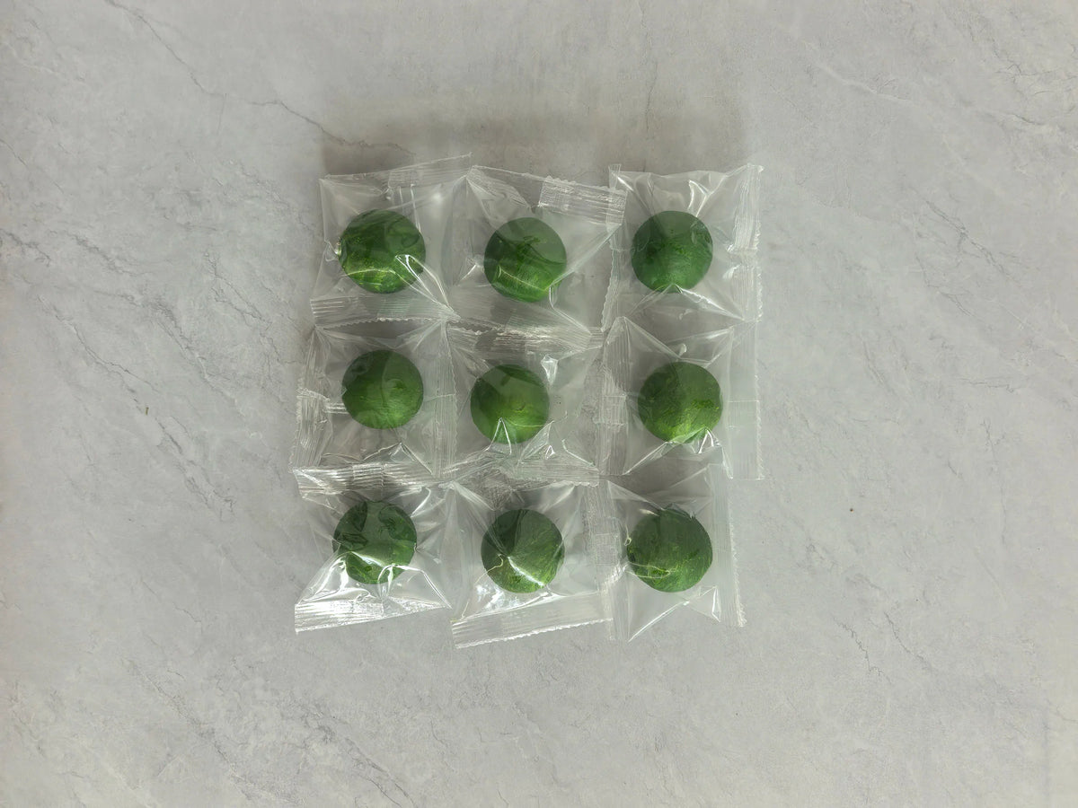 Nine green rodent repellent balls in individual clear plastic wrappers