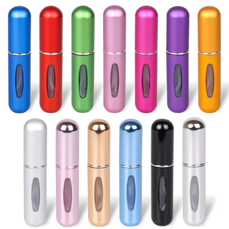 A collection of empty portable perfume atomizer bottles in various colors.
