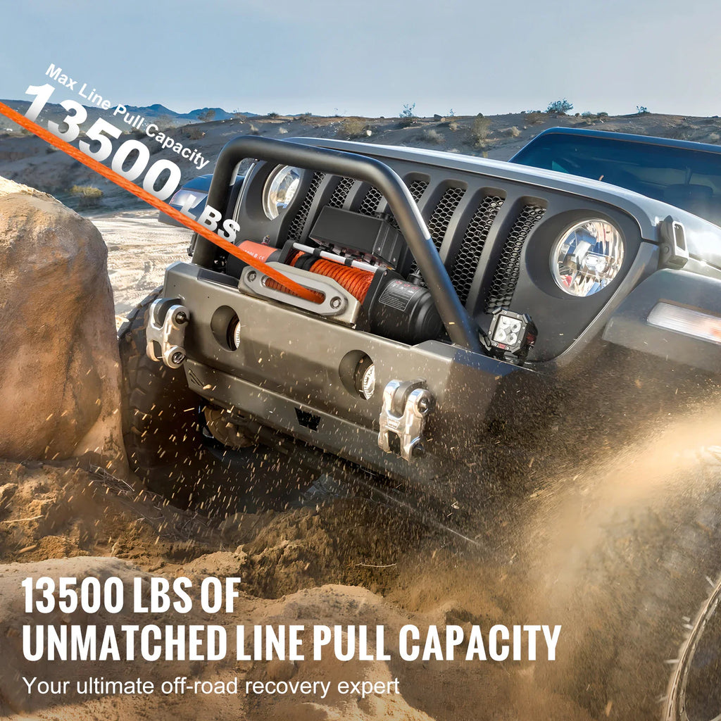 Heavy-duty electric winch mounted on a black off-road vehicle bumper in a desert