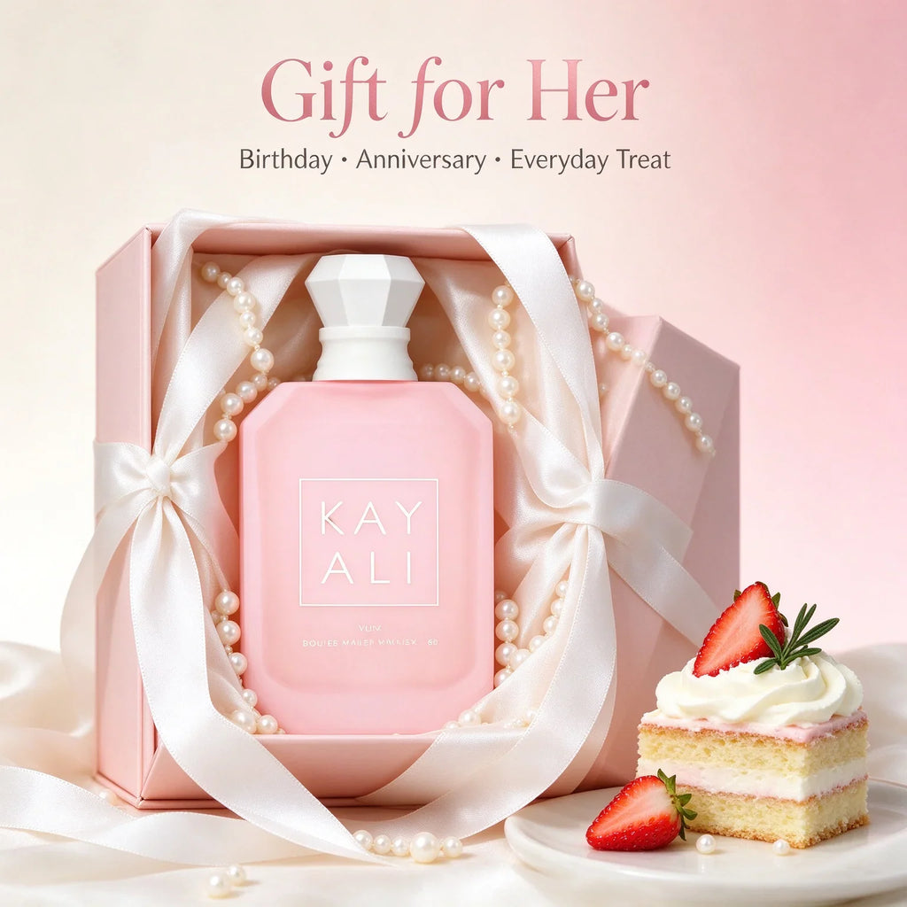 A pink 30ml perfume bottle in a gift box with pearls and a piece of strawberry cake.