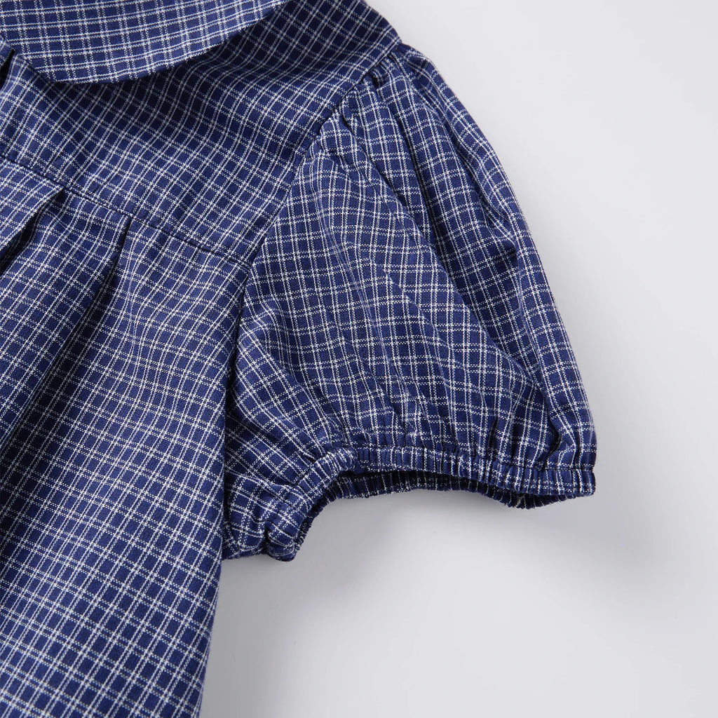 Puff sleeve detail of blue plaid short-sleeve shirt